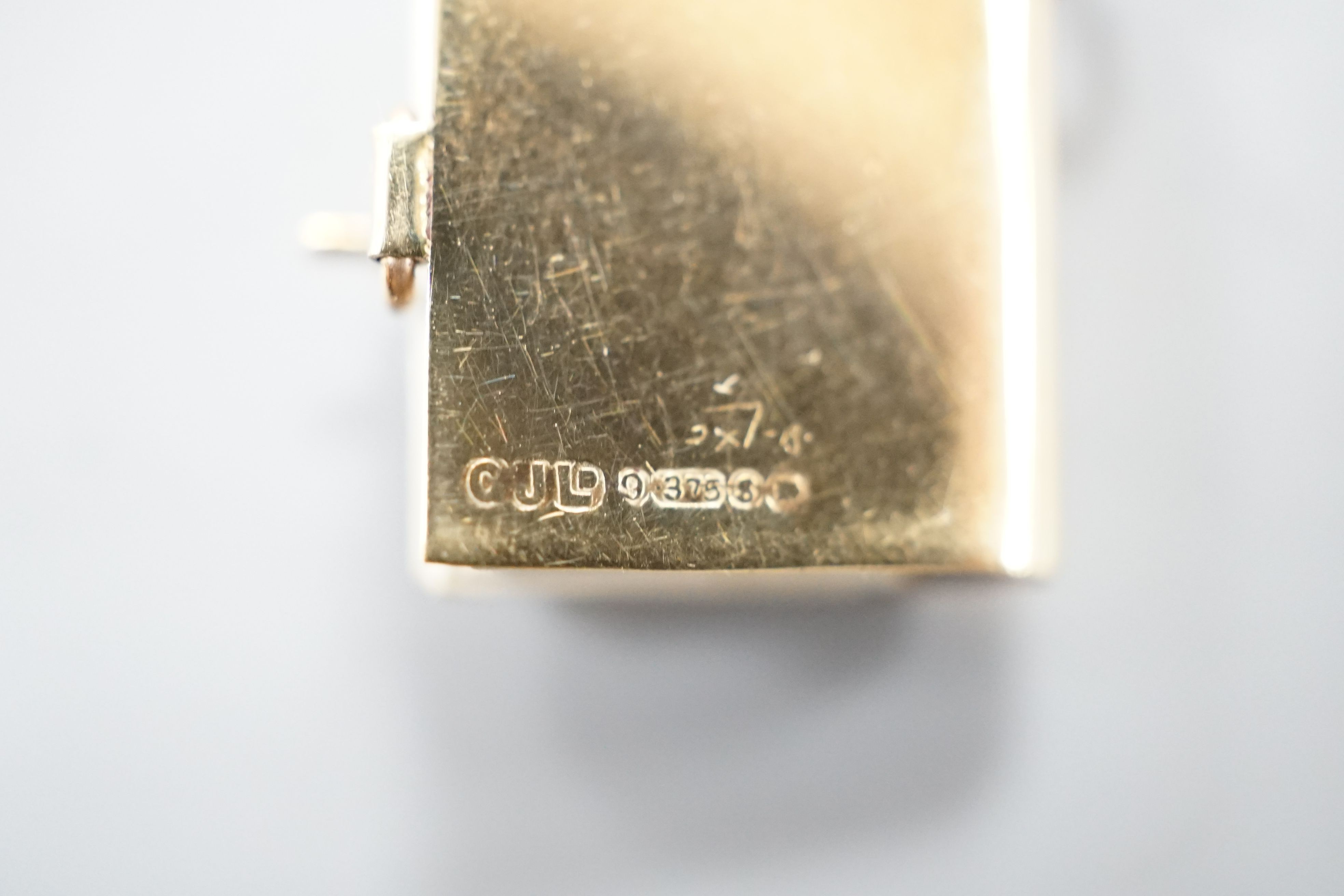 An enamelled 9ct gold photograph album charms with views and crest of London, 1.5cm gross 3.1 grams